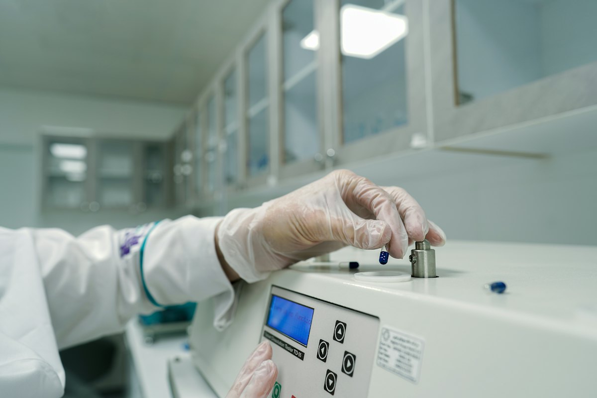 Operator adjusting a laboratory instrument
